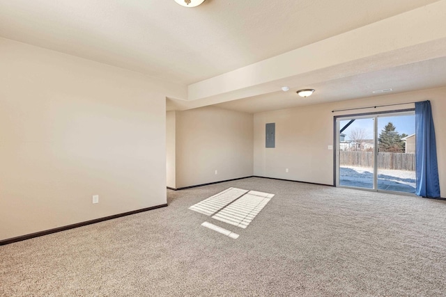 carpeted spare room with electric panel