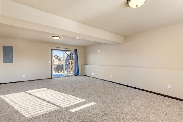 empty room featuring beamed ceiling, carpet floors, and electric panel