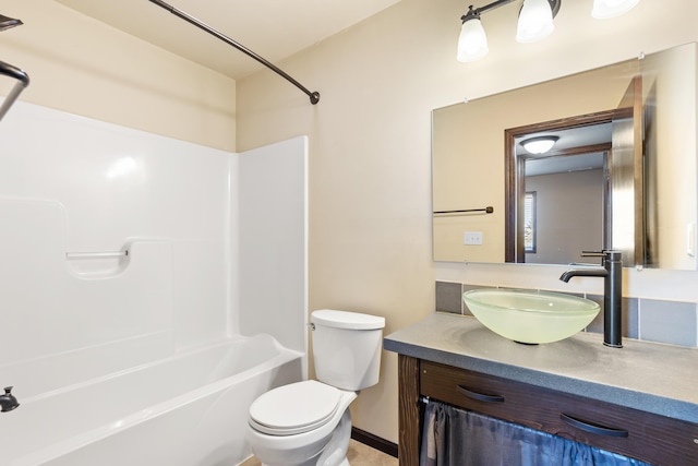 full bathroom with vanity, toilet, and  shower combination