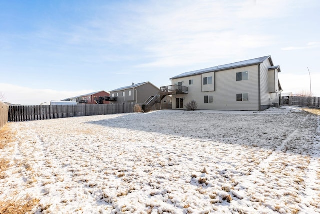 rear view of property featuring a deck