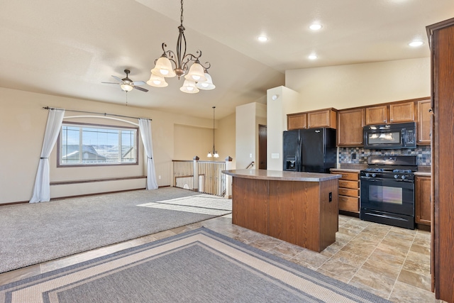 kitchen with pendant lighting, decorative backsplash, a center island, and black appliances