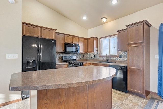 kitchen featuring black appliances, sink, vaulted ceiling, a kitchen island, and a kitchen bar