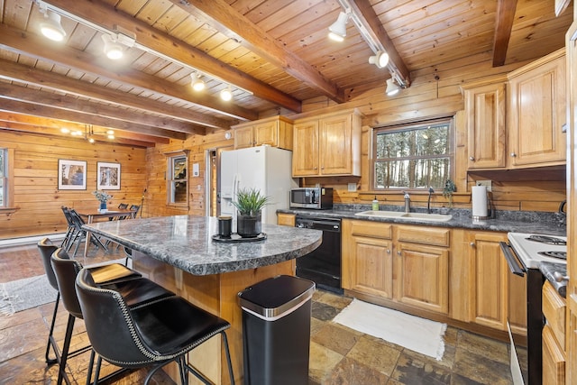 kitchen with a center island, white appliances, sink, wooden walls, and beamed ceiling