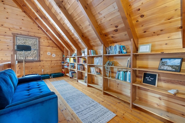 living area featuring vaulted ceiling with beams, wood walls, wooden ceiling, and wood-type flooring