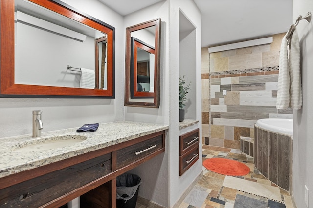 bathroom with vanity and a washtub