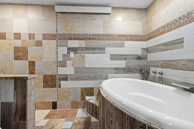 bathroom with a relaxing tiled tub