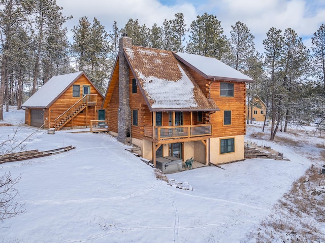 view of snow covered back of property