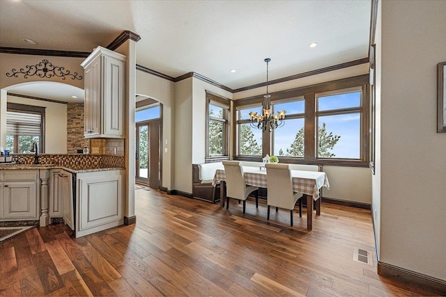 kitchen with dark hardwood / wood-style floors and ornamental molding