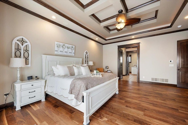 bedroom featuring ceiling fan, dark hardwood / wood-style flooring, crown molding, and coffered ceiling