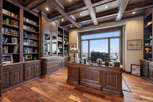 office space featuring beamed ceiling, built in shelves, light wood-type flooring, and ornamental molding