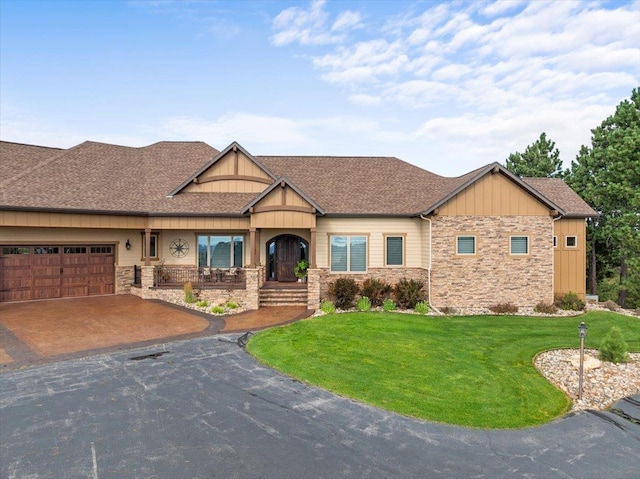 craftsman-style home featuring a front yard and a garage