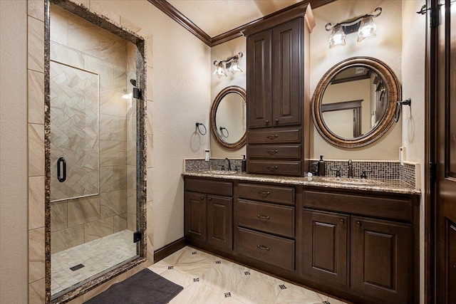 bathroom with vanity, a shower with shower door, and crown molding