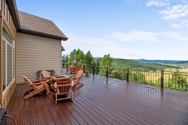 wooden terrace featuring a fire pit and a mountain view