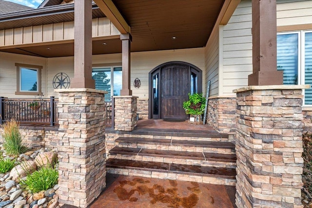 view of exterior entry with covered porch