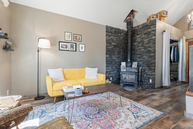 living room featuring lofted ceiling, a wood stove, and dark wood-type flooring