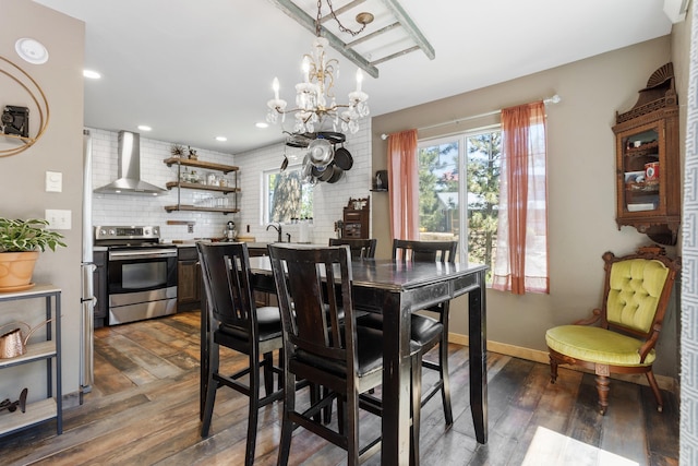 dining room with dark hardwood / wood-style floors and an inviting chandelier