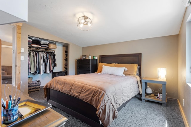 carpeted bedroom with vaulted ceiling and a closet