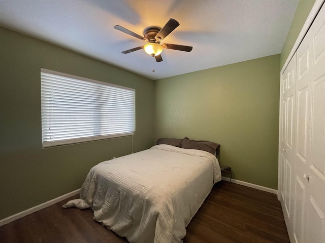 bedroom with a closet, ceiling fan, and dark wood-type flooring