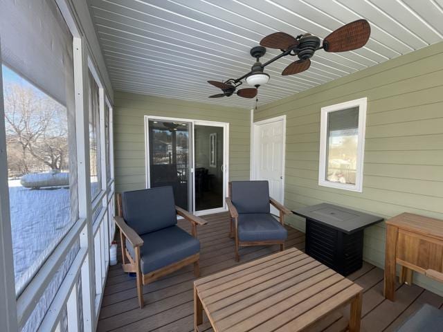 sunroom / solarium featuring ceiling fan