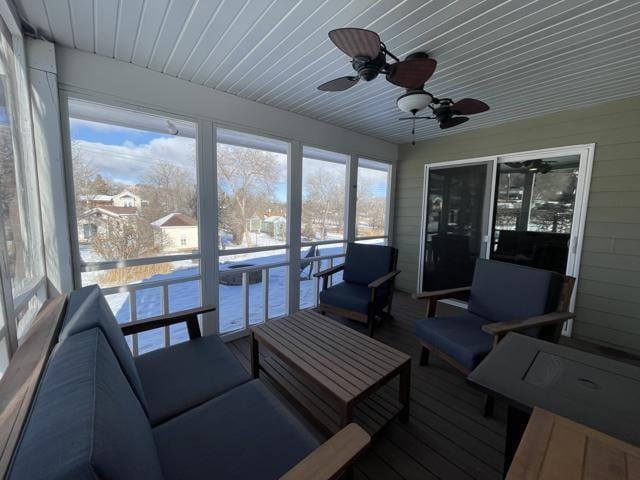 sunroom / solarium featuring a wealth of natural light, ceiling fan, and wooden ceiling