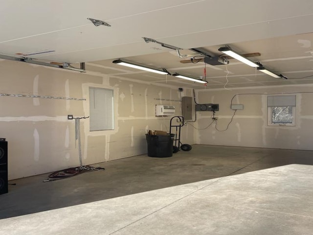 garage with a garage door opener and electric panel