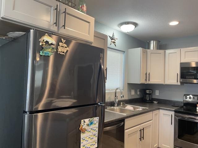 kitchen with white cabinets, stainless steel appliances, and sink