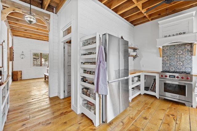 kitchen featuring light wood finished floors, appliances with stainless steel finishes, and pendant lighting