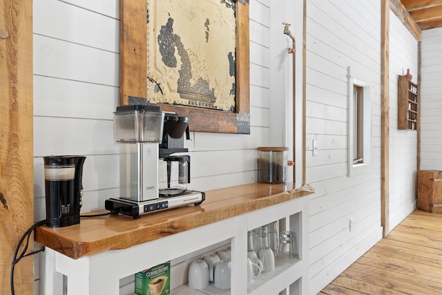 kitchen featuring wood walls, wood counters, and light wood-style floors