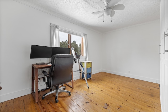 office space featuring crown molding, a textured ceiling, a ceiling fan, and hardwood / wood-style floors