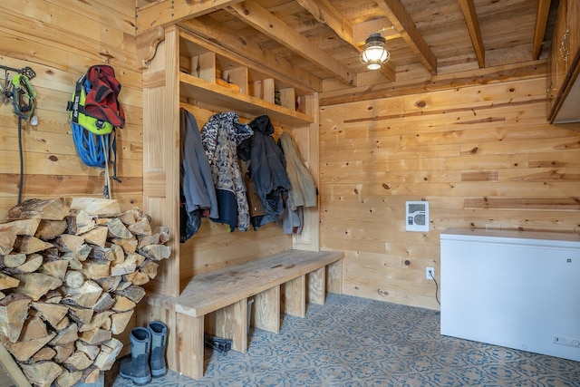 mudroom featuring beamed ceiling, wooden ceiling, and wooden walls