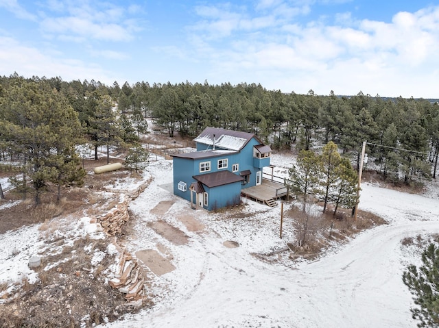 snowy aerial view featuring a view of trees