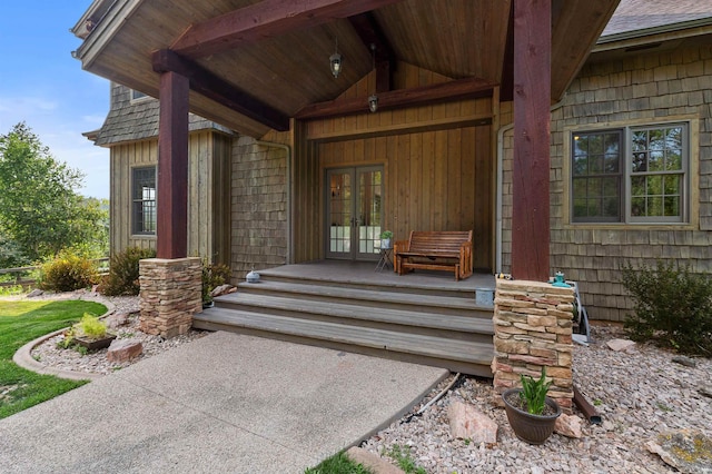 doorway to property featuring covered porch and french doors