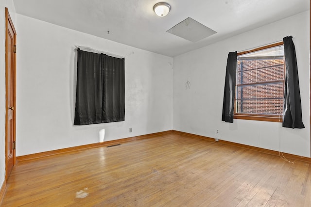 empty room with light hardwood / wood-style flooring