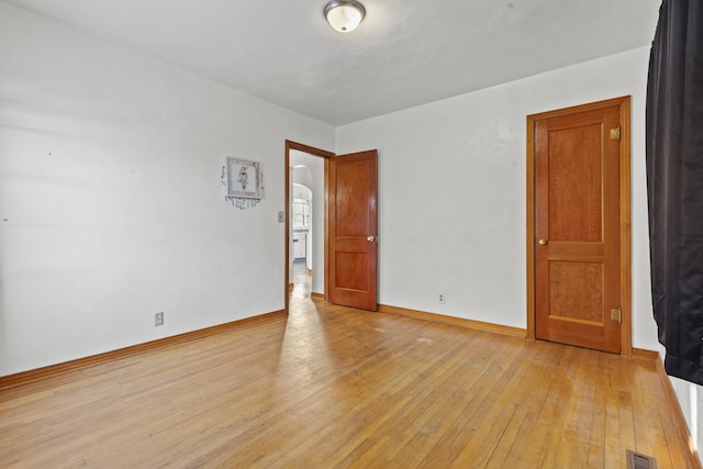 spare room featuring light hardwood / wood-style flooring