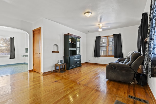 living area featuring ceiling fan and hardwood / wood-style flooring