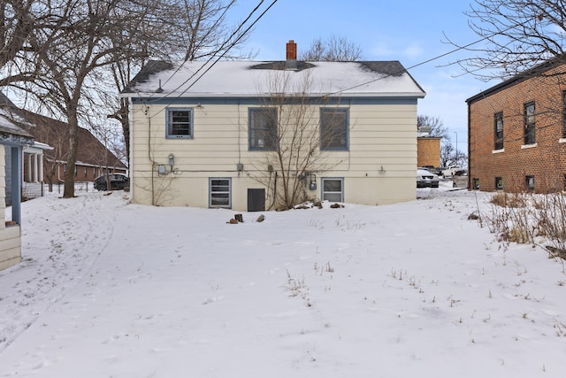 view of snow covered rear of property