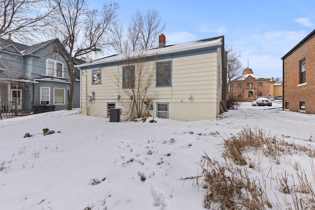 view of snow covered rear of property