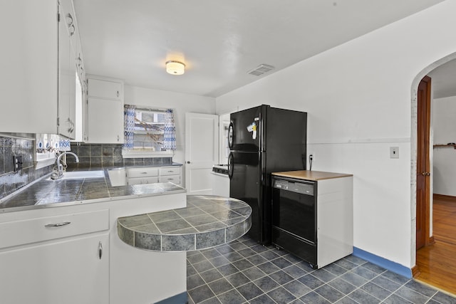 kitchen with sink, white cabinets, and black appliances