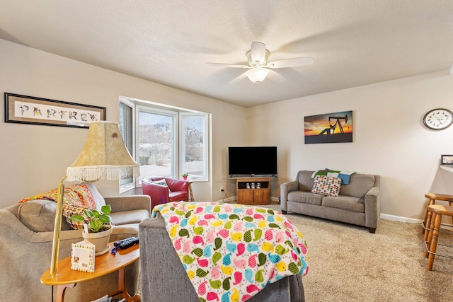 living room with ceiling fan, carpet floors, and a textured ceiling