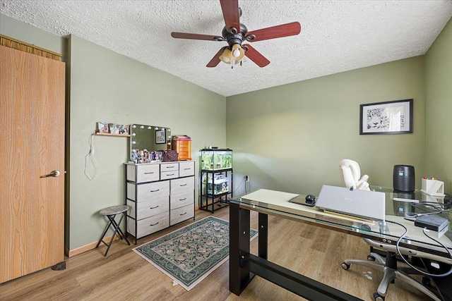 office with ceiling fan, light hardwood / wood-style flooring, and a textured ceiling