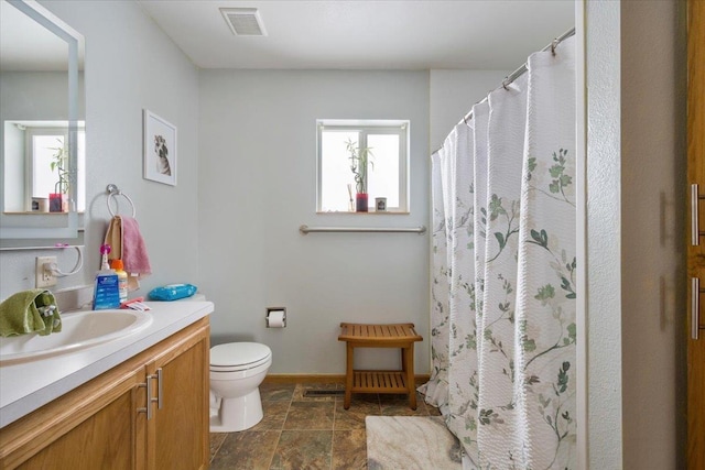 bathroom with vanity, curtained shower, and toilet