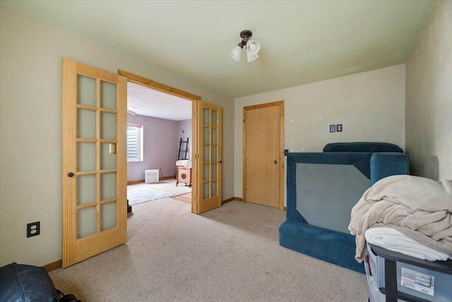 sitting room with light colored carpet and french doors