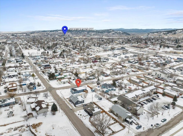 snowy aerial view featuring a mountain view