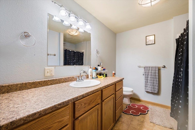 bathroom featuring tile patterned flooring, vanity, and toilet