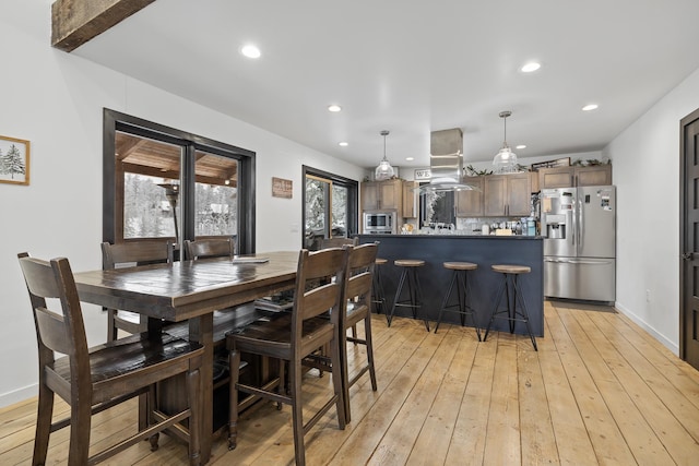 dining space featuring light wood-type flooring