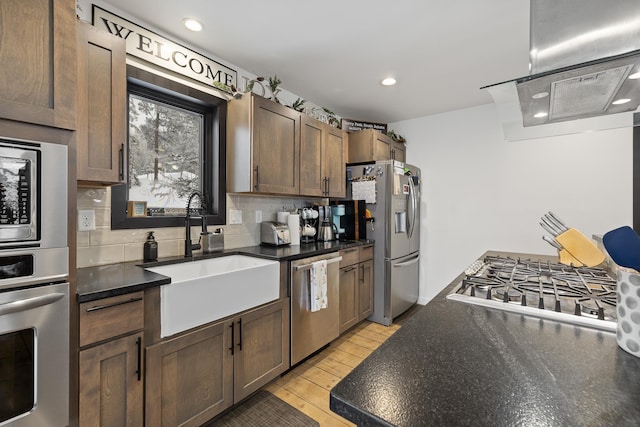 kitchen featuring appliances with stainless steel finishes, tasteful backsplash, and sink