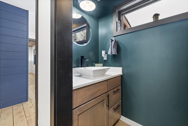 bathroom with hardwood / wood-style flooring, a healthy amount of sunlight, and vanity