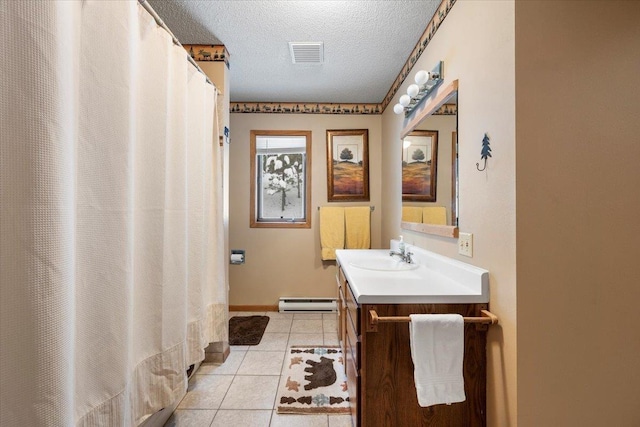 bathroom featuring a textured ceiling, baseboard heating, vanity, and tile patterned floors