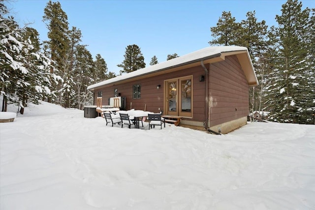 view of snow covered back of property