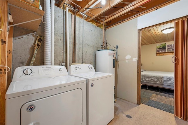 laundry room featuring water heater and washer and clothes dryer